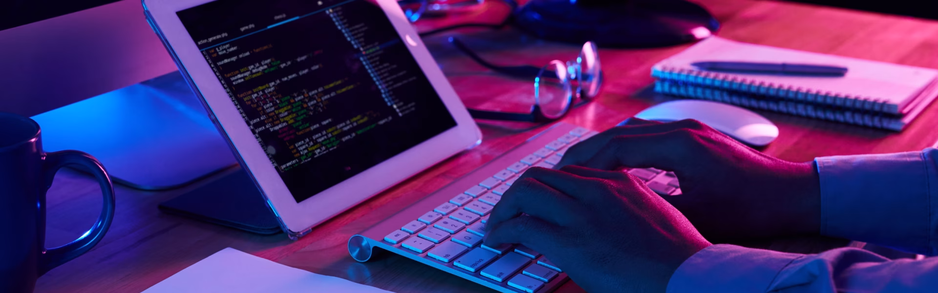 Close-up image of programmer working at his desk in office